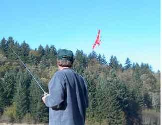 A FunFlyers member enjoys flying a model airplane
               on a bright sunny day